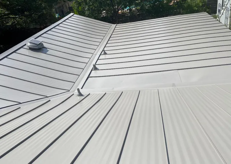 Solar attic fan installed on a metal roof for Roof Ventilation in Lake Oswego